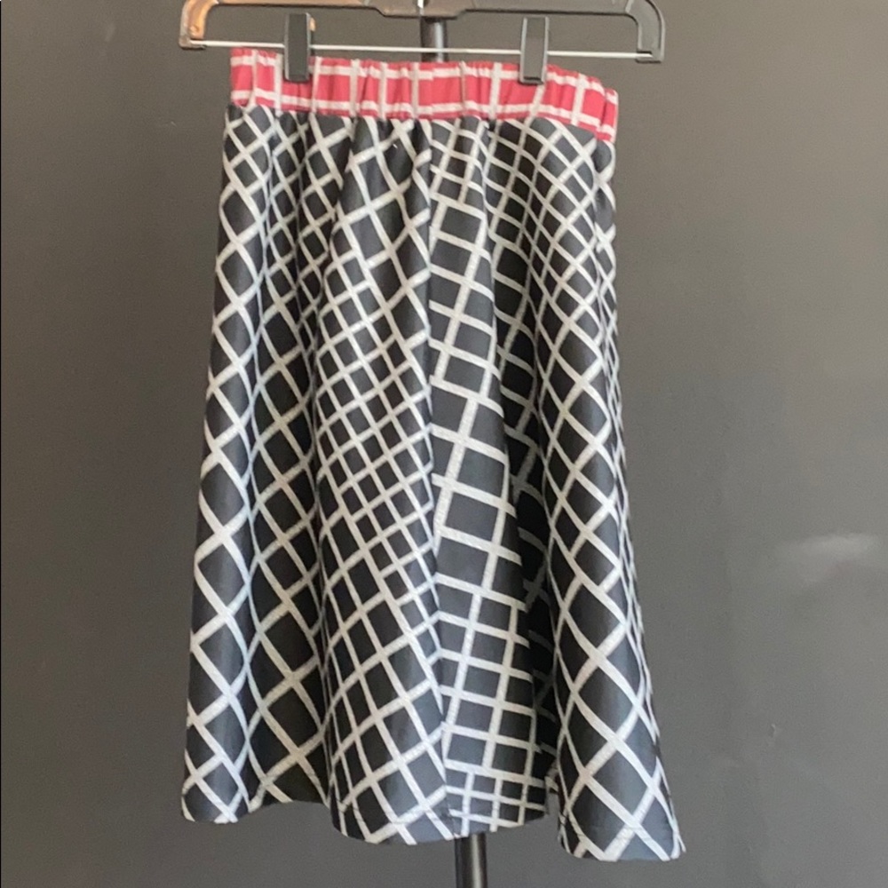 A black skirt with a red light on top
